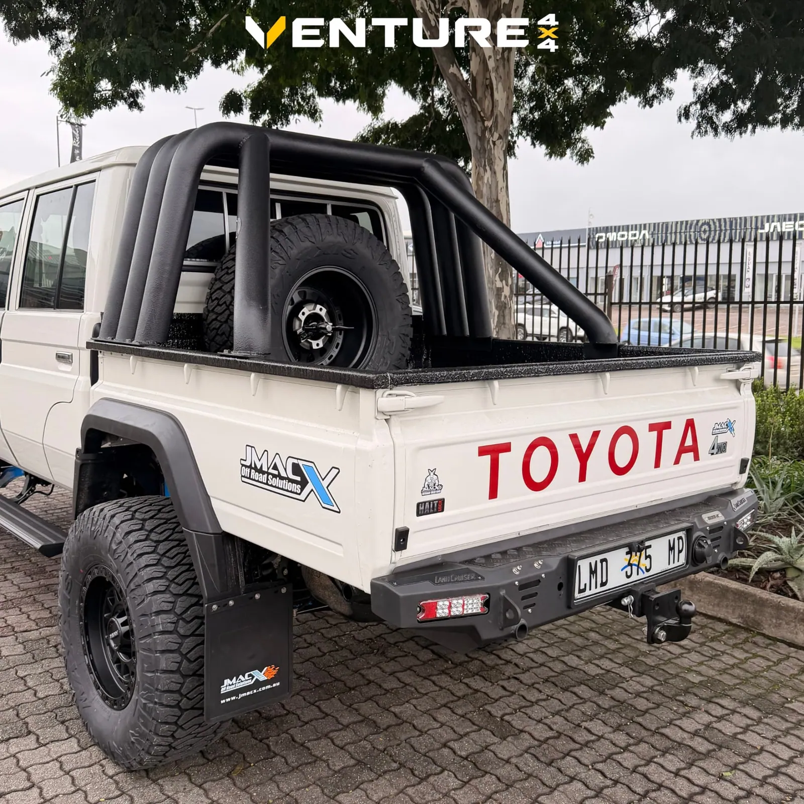 Rear three-quarter view with roll bar and JMACX rear bar — King Cruiser — JMACX Coil-Converted Land Cruiser 79, fitted by Venture 4x4 in Nelspruit
