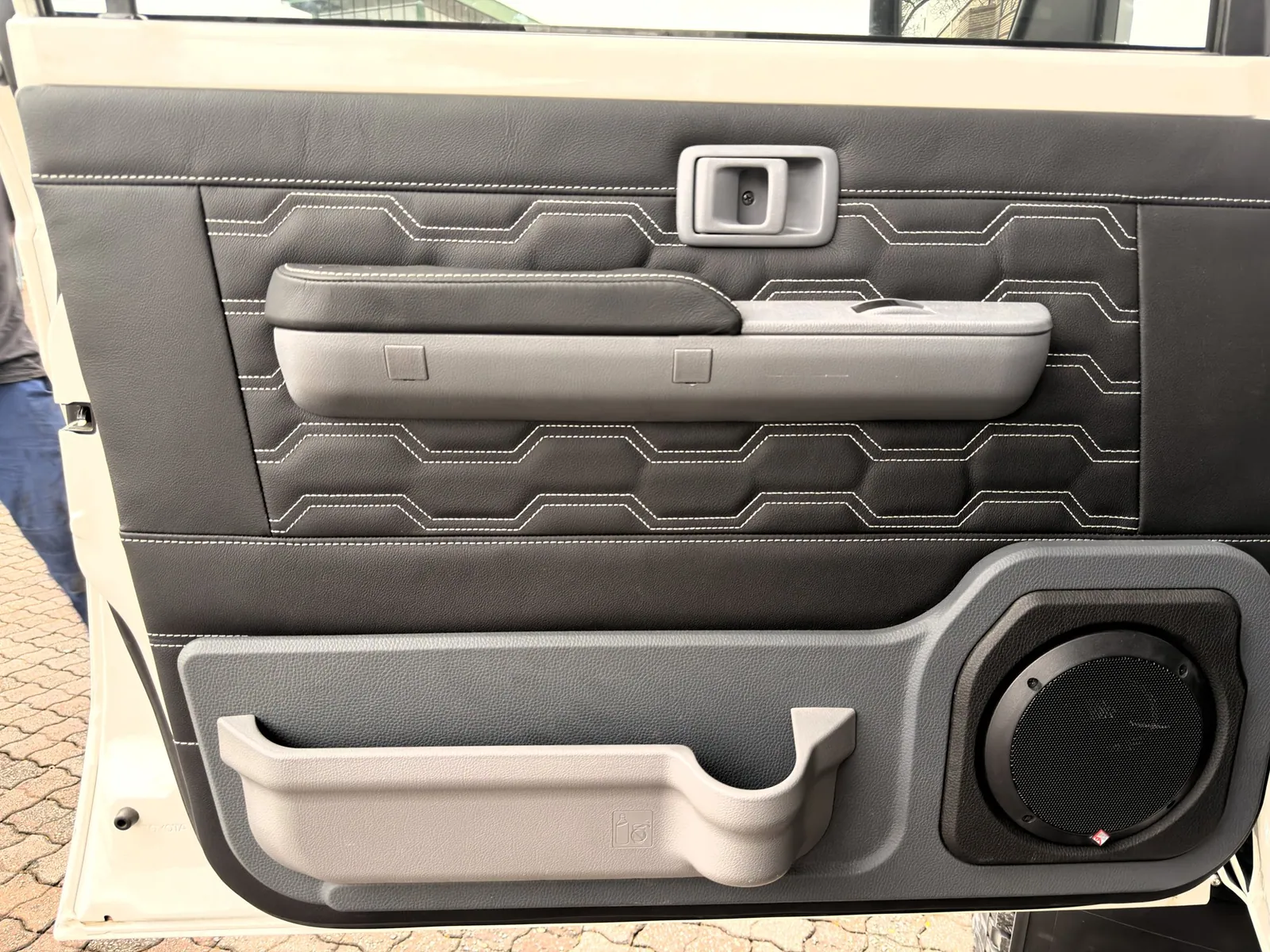 Custom stitched leather door trim with upgraded speaker — King Cruiser — JMACX Coil-Converted Land Cruiser 79, fitted by Venture 4x4 in Nelspruit