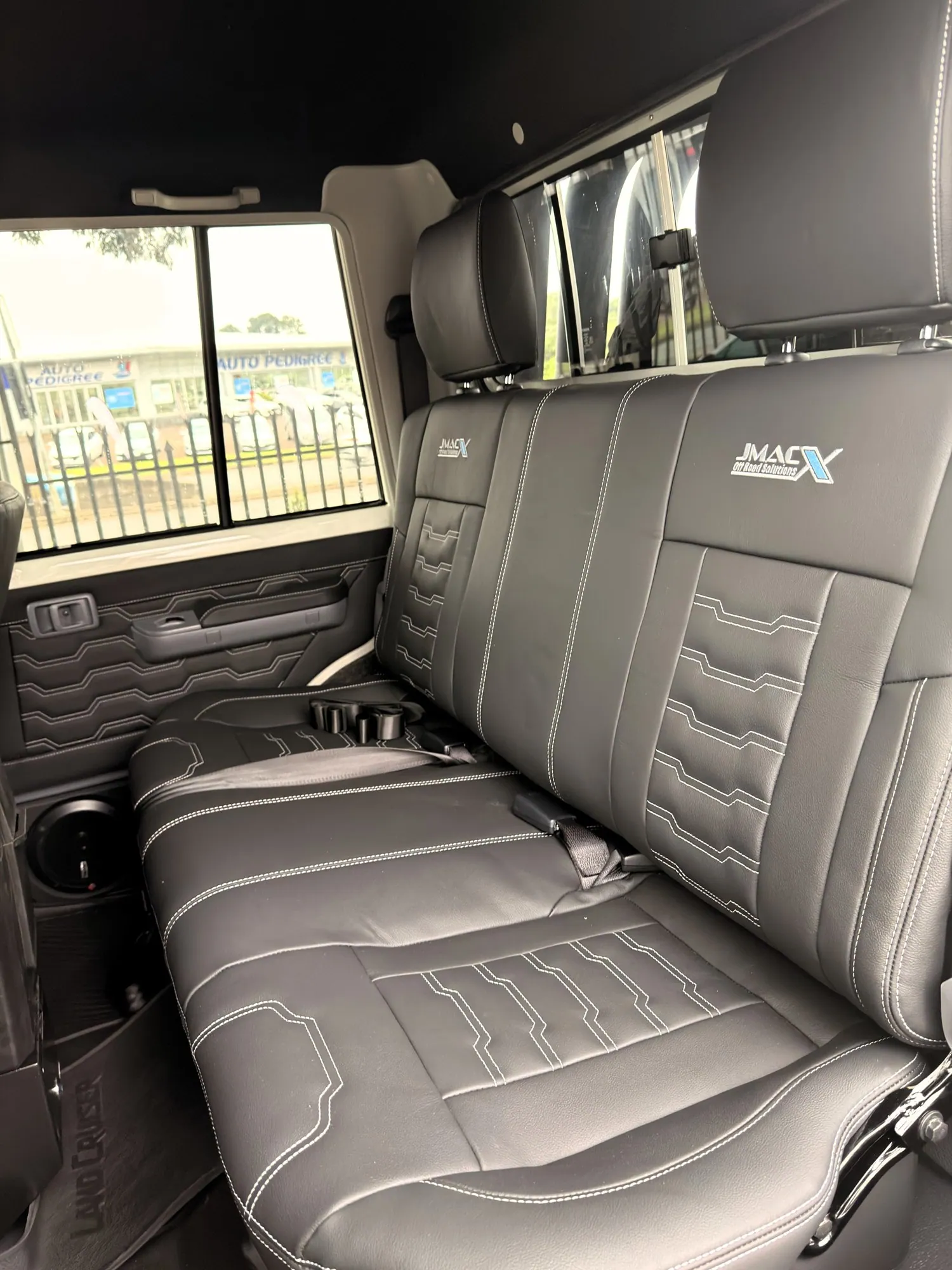 JMACX-branded leather rear bench seat — King Cruiser — JMACX Coil-Converted Land Cruiser 79, fitted by Venture 4x4 in Nelspruit